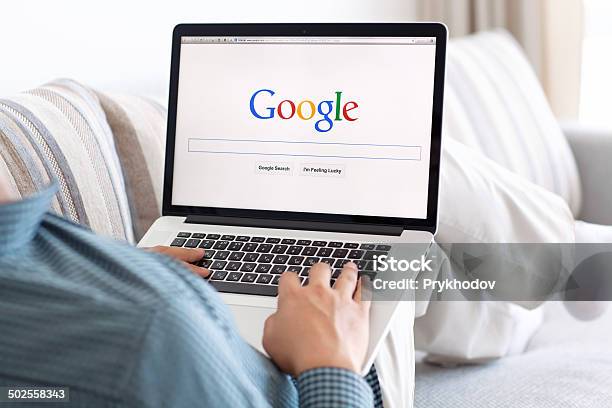 Man Sitting The Macbook Retina With Site Google On Screen Stock Photo - Download Image Now