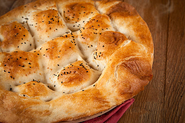 Turkish Ramadan Bread, Ramazan Pidesi on wooden table stock photo