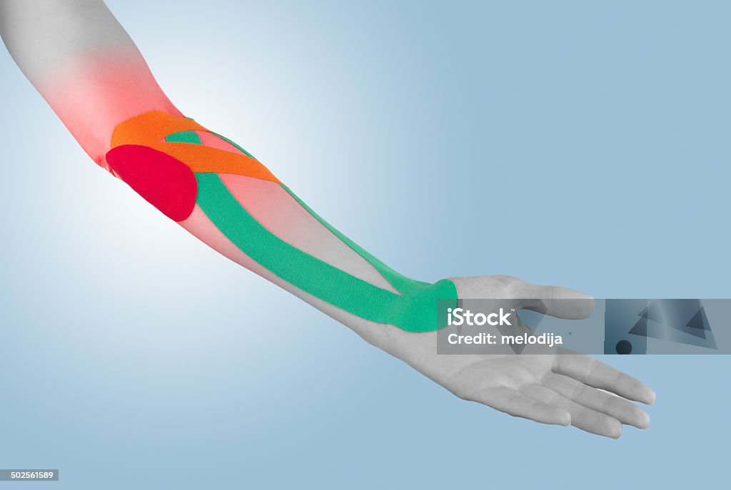 Physiotherapy for elbow pain, aches and tension Physiotherapy treatment with therapeutic tape for elbow pain, aches and tension. It is also used for prevention and treatment in competitive sports. Anatomy Stock Photo