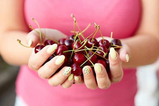 istock Woman holding fresh cherries 502562041