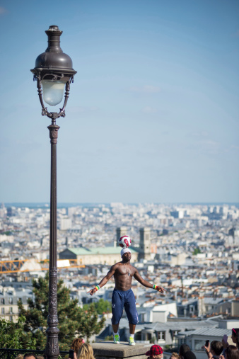 Paris, France - May 15, 2014: Soccer player makes a soccer freestyle demonstration in front of Sacre Coeur church.