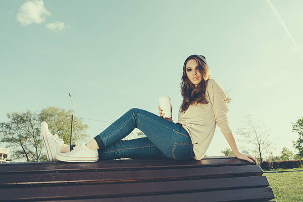 istock beautiful girl sitting on a bench 502564595