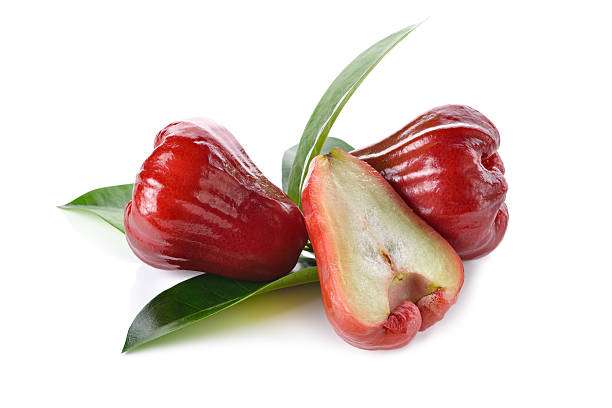 istock whole and half cut rose apple on white background 502575572