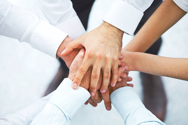 istock International business team showing unity with their hands toget 502576976