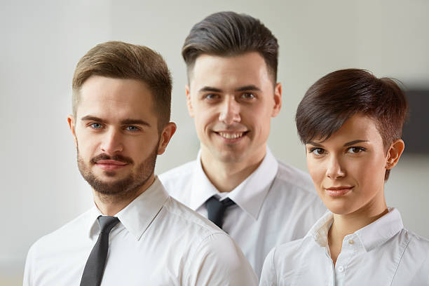 istock Business Team. Happy smiling people standing in office 502577524