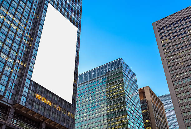 Blank billboard and  high rise business building at night time