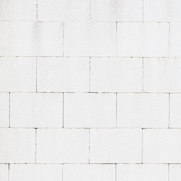 istock Texture and seamless background of white granite stone wall 502578376