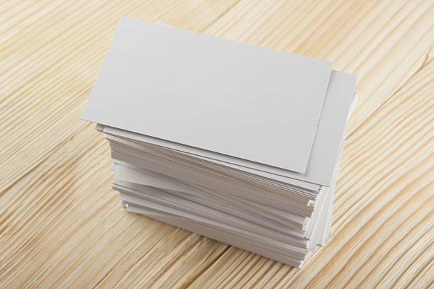 istock White blank business visit card, ticket, pass, present  wooden background 502579704