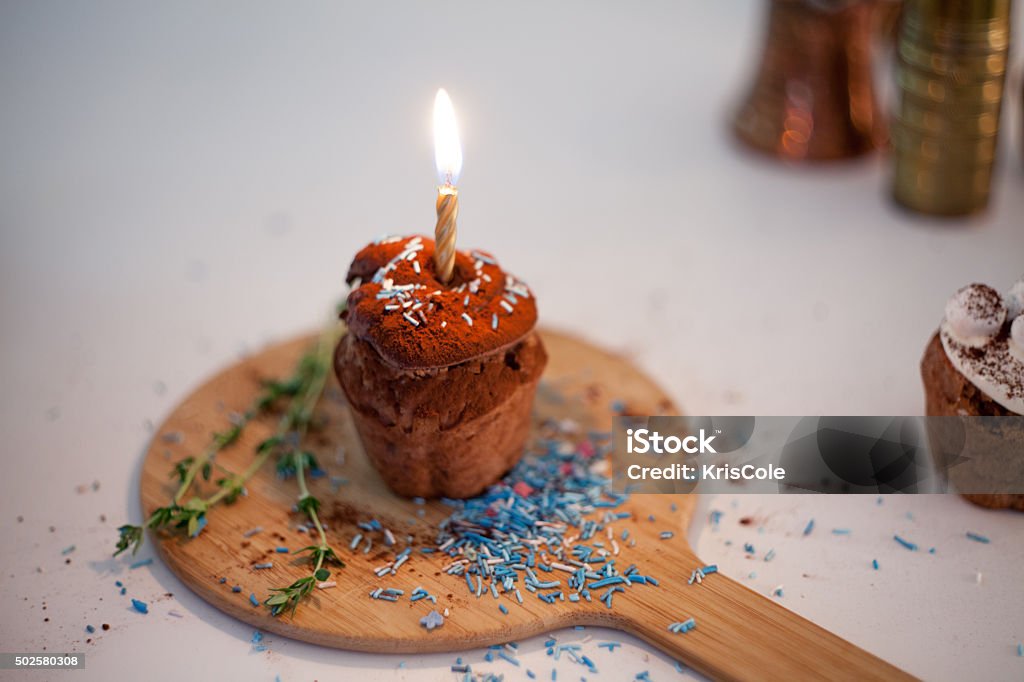 tasty birthday cupcake with candle on the table, blurred background tasty birthday cupcake with candle on the table 2015 Stock Photo