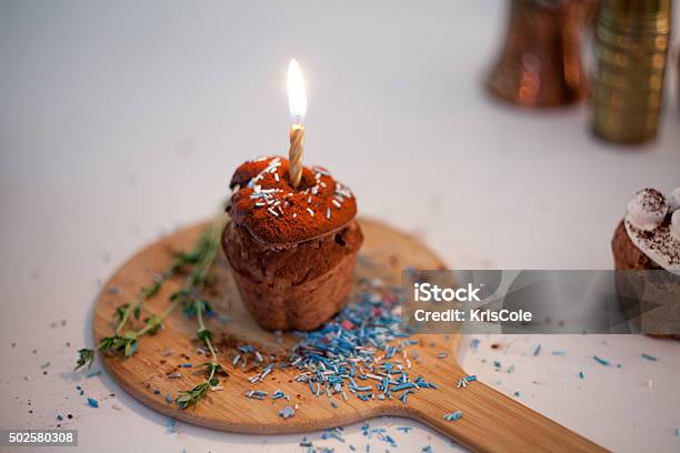 Tasty Birthday Cupcake With Candle On The Table Blurred Background Stock Photo - Download Image Now