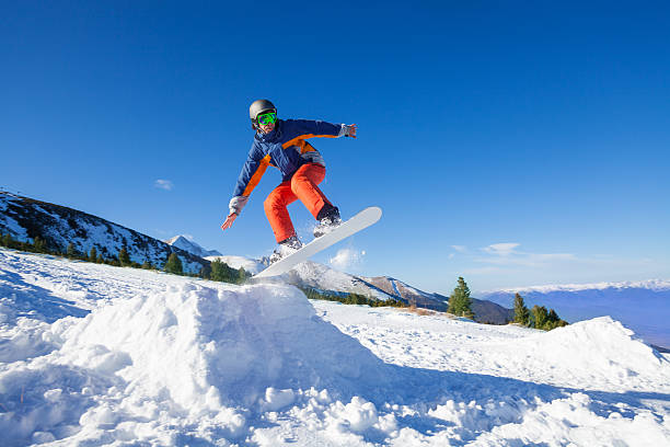 istock Snowboarder jumping high from hill in winter 502580549