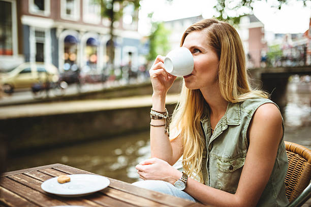 istock Woman holding a coffee cup in amsterdam 502581373