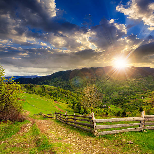 istock fence on hillside meadow in mountain at sunset 502581445