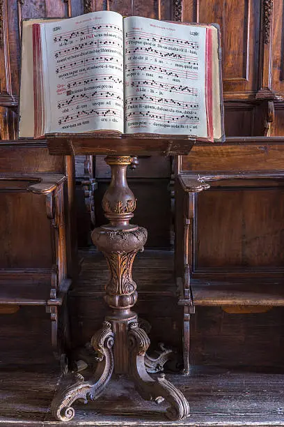 old religious music  sheet on a wood music stand