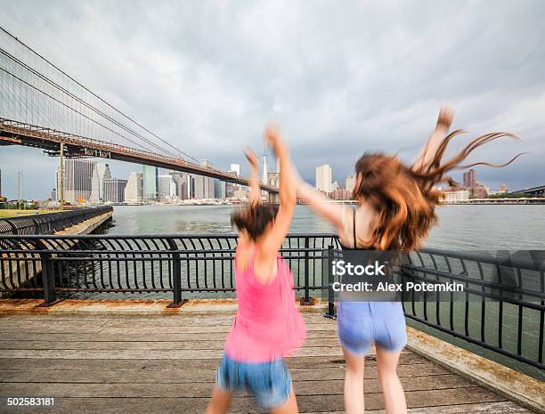Two Girls Sisters Looking To Manhattan Under Thunderstorm Stock Photo - Download Image Now