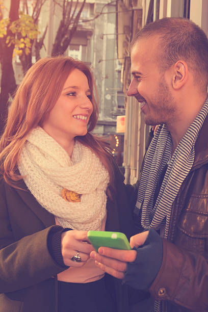 istock Couple in love using cellphone outdoors. 502583192