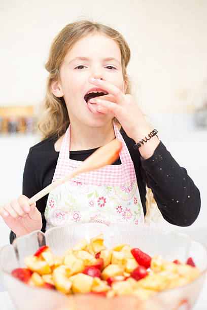istock Little Girl Licks her fingers 502583943
