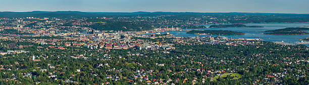 Aerial view over Oslo green cityscape and fjords panorama Norway Sweeping aerial panoramic vista across Oslo, Norway's picturesque capital city, from the leafy green suburbs and tranquil housing to the modern downtown developments and historic landmarks looking out over the blue waters of Oslofjorden. ProPhoto RGB profile for maximum color fidelity and gamut. jetty aerial stock pictures, royalty-free photos & images