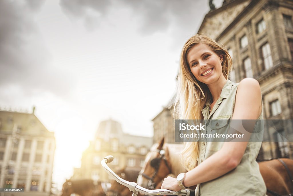 Dutch woman with bicycle in amsterdam walking http://blogtoscano.altervista.org/amtu.jpg Street Stock Photo