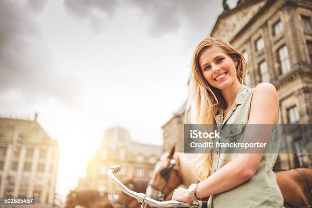 Dutch Woman With Bicycle In Amsterdam Walking Stock Photo - Download Image Now - Street, 20-29 Years, Active Lifestyle