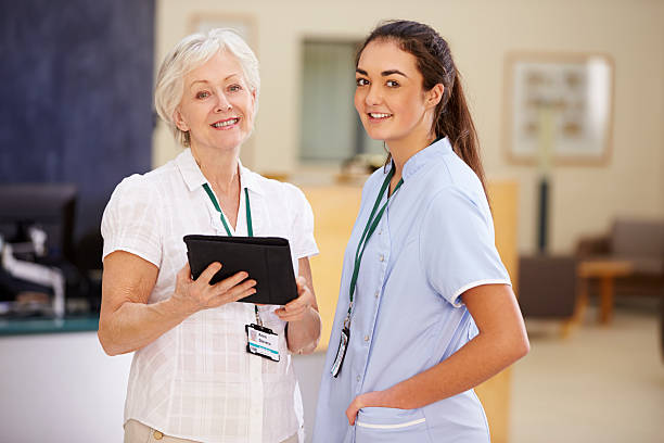 istock Female Consultant In Meeting With Nurse Using Digital Tablet 502585871
