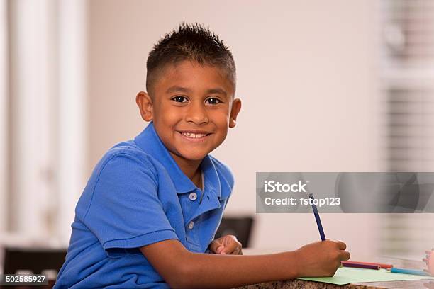 Cute Hispanic Boy Does Homework In Home Kitchen Stock Photo - Download Image Now - Boys, Child, Latin American and Hispanic Ethnicity