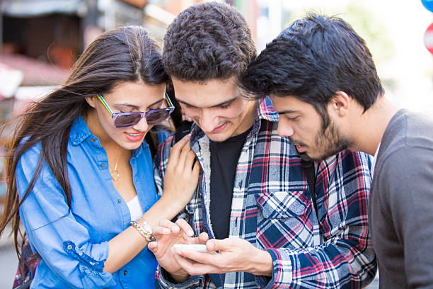 istock Young Turkish people looking at smart phone 502586258