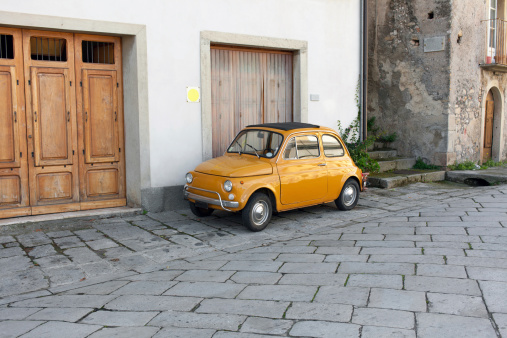 Little vintage car on the street of Novara di Sicilia. Sicily. Italy