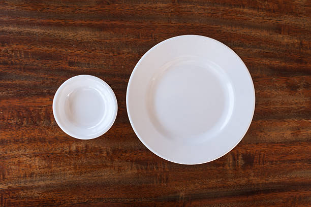 istock Empty white plate and small chalice on wooden background 502589206