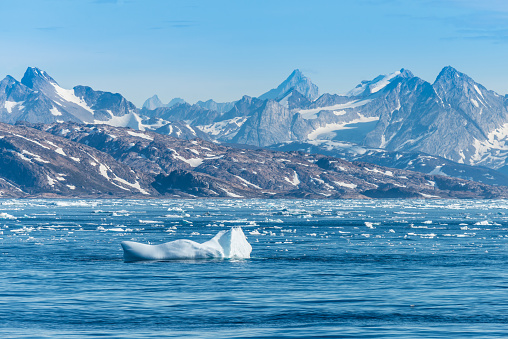 Eastcoast of Greenland in front of Ammassalik (Tasiilaq). in the foreground floating ice sheet and iceberg in the Denmark Strait.
