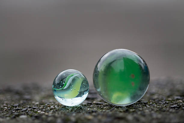 istock Two marbles on the sidewalk in close up. 502589954