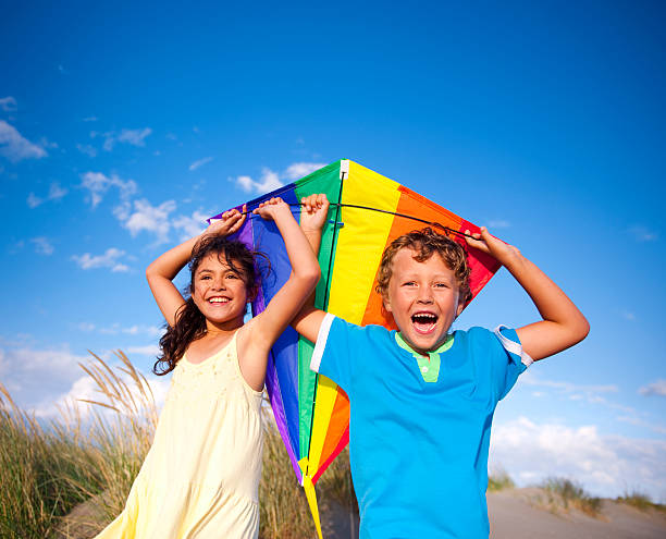 istock Cheerful Children Playing Kite Outdoors 502601147