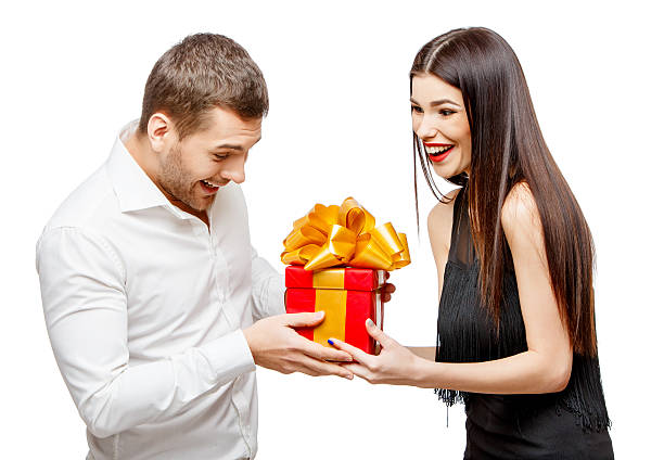 istock Young beautiful couple with present isolated on white 502604242