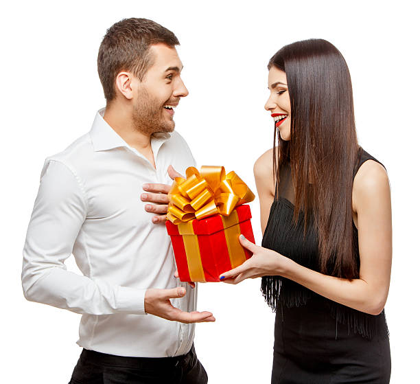 istock Young beautiful couple with present isolated on white 502604250