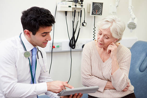 istock Consultant Showing Patient Test Results On Digital Tablet 502605261