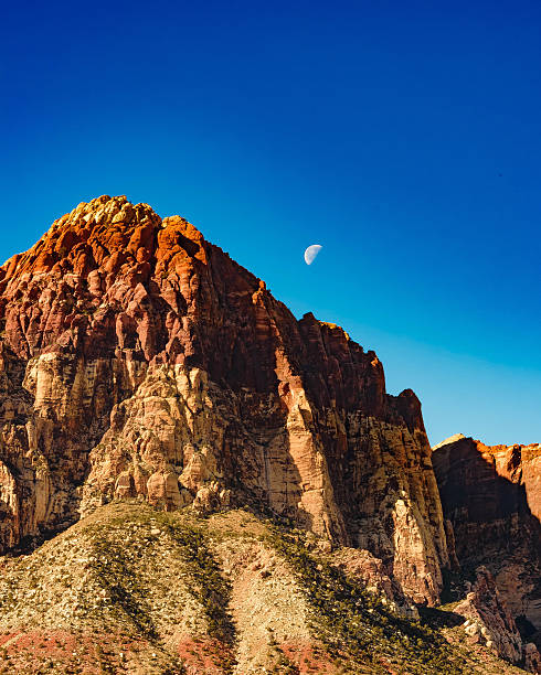The moon setting over a peek at Red Rock Canyon Recreation Area, outside of Las Vegas, NV.