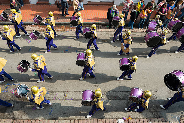 St. Augustine High School marching band at Mardi Gras in New Orleans New Orleans, Louisiana, USA - February 8, 2013: St. Augustine High School's "Marching 100" parades down Bourbon Street in the French Quarter of New Orleans, part of Mardi Gras festivities in the city. bass drum photos stock pictures, royalty-free photos & images