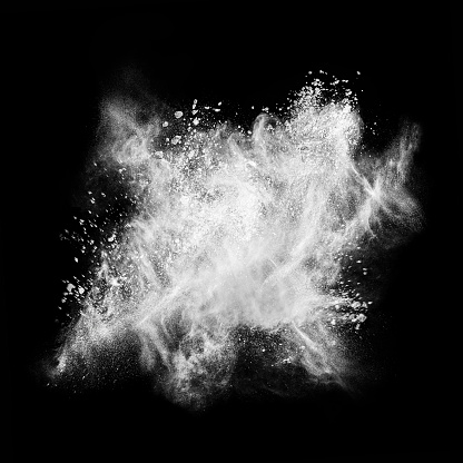 Abstract exploding white powder isolated on black background.