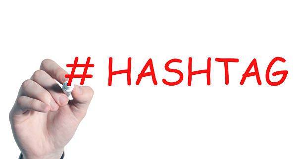 istock Businessman writing #Hashtag with marker on transparent board. 502608344