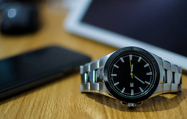 istock Black dial wristwatch on wooden table 502609042