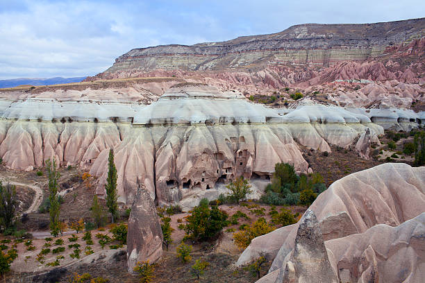 Unique geological formations in Red Valley in Cappadocia, Central Anatolia, Turkey. Cappadocian Region with its valley, canyon, hills, caves located between the volcanic mountains Erciyes, Melendiz and Hasan.