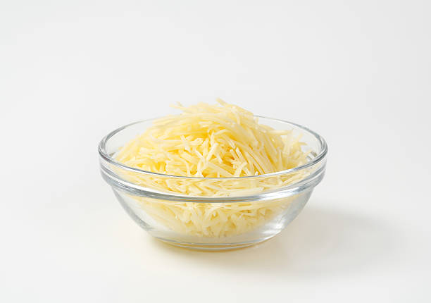 Grated cheese Grated cheese in a glass bowl white cheese stock pictures, royalty-free photos & images