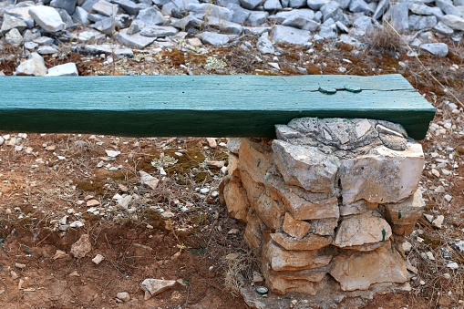 Detail of a bench made with wood and stone. In Vela Luka, Korcula island, Croatia.