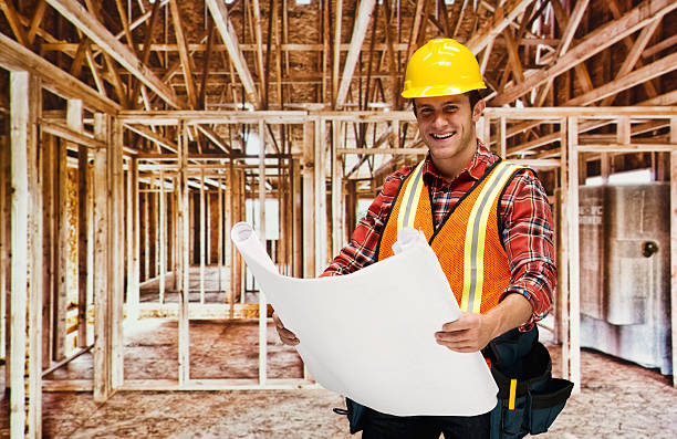 Smiling male architect holding blueprint Smiling male architect holding blueprinthttp://www.twodozendesign.info/i/1.png 24 x 24 frame stock pictures, royalty-free photos & images