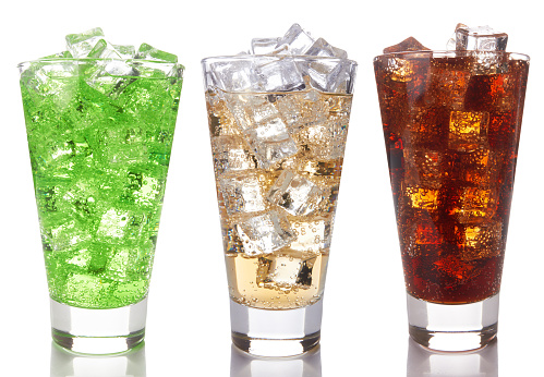 Glasses with sweet drinks with ice cubes isolated on white