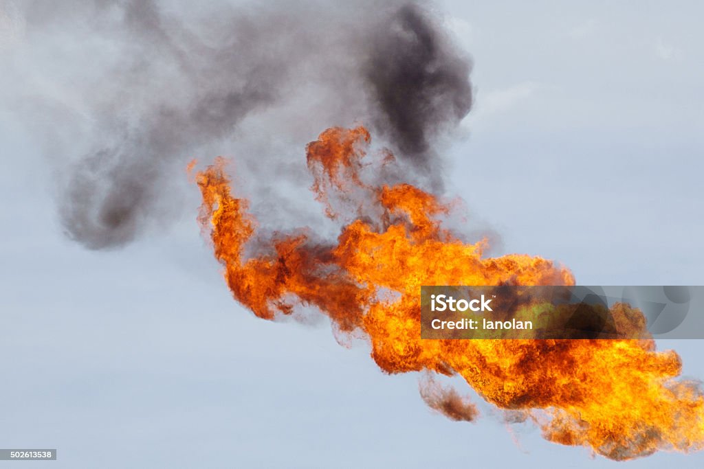 Fire torching against the sky Fire torching against the sky burning gas flaring. Malaysia Stock Photo