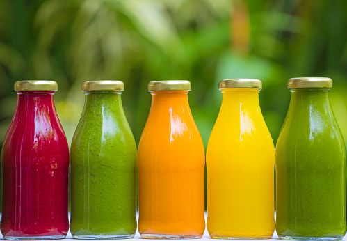 Organic cold-pressed raw vegetable juices in glass bottlesOrganic cold-pressed raw vegetable juices in glass bottles