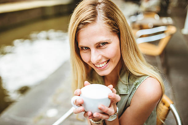 istock Woman holding a coffee cup in amsterdam 502616885