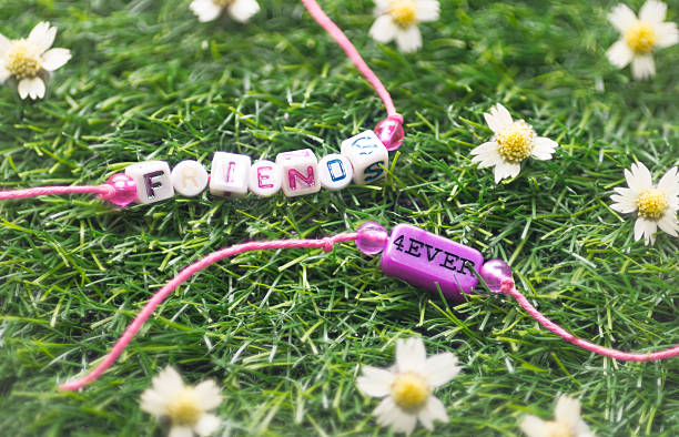 two friendship bracelet on grass stock photo