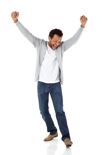 Full length portrait of happy mature man standing with his hands raised and smiling over white background